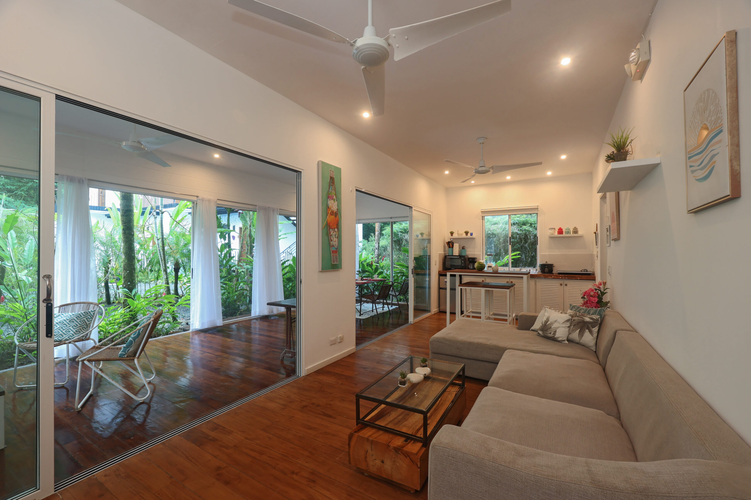 Modern resort suite with balcony, garden views & contemporary design