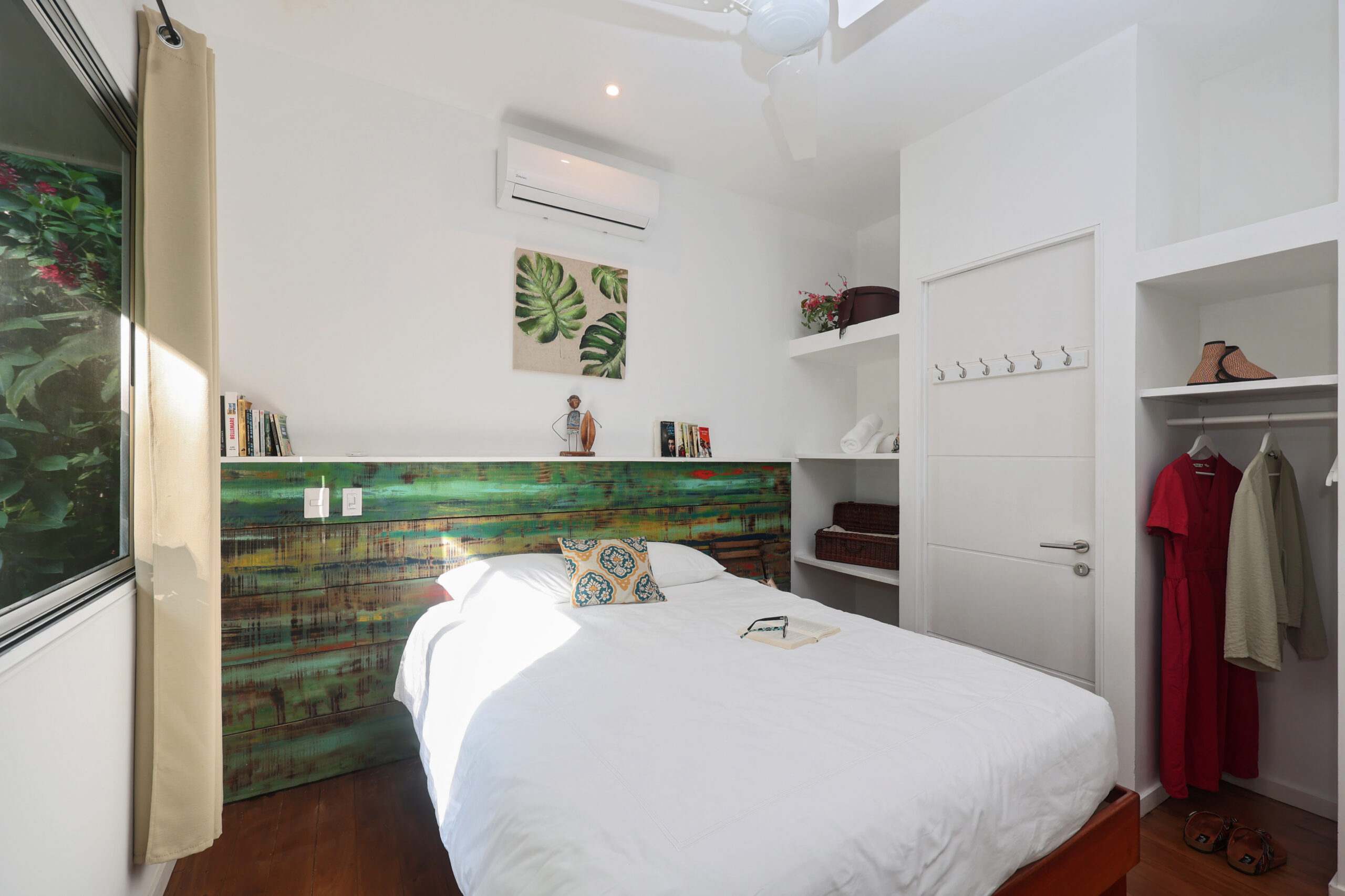 Twin bed villa room at Ojochal Gardens with wooden furniture and garden balcony views