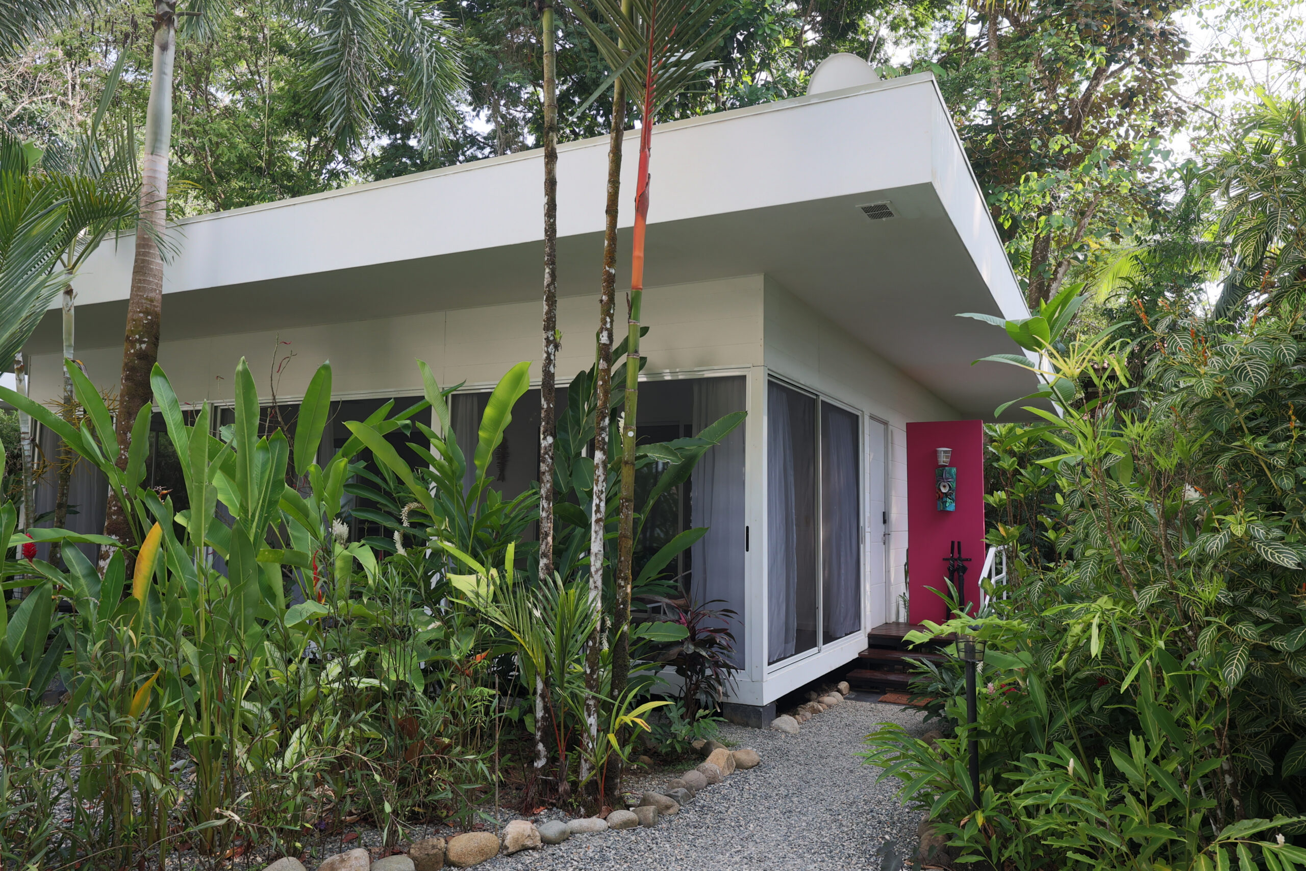 Twin bed resort room with modern amenities & tropical garden access