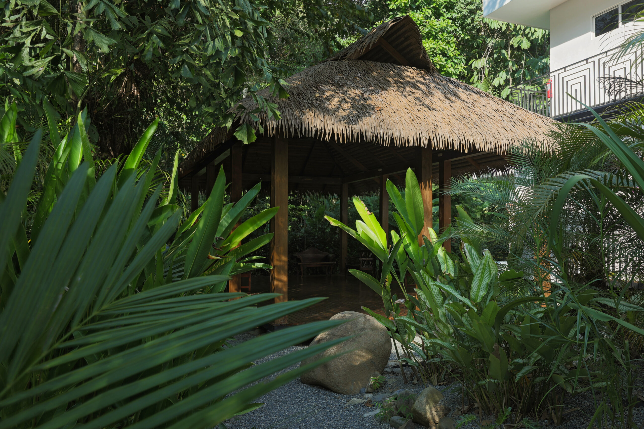 Luxury outdoor daybed surrounded by lush tropical gardens at Ojochal Costa Rica villa